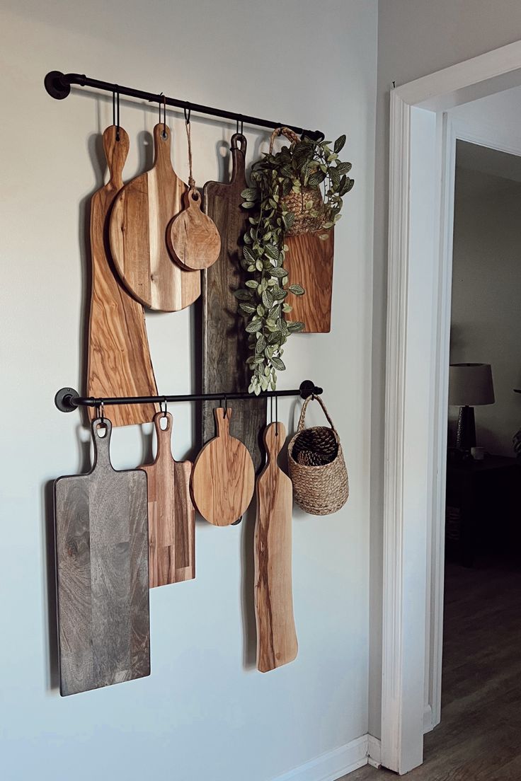 several wooden cutting boards hanging on a wall