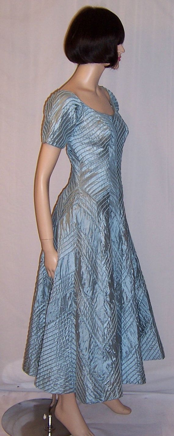 This Ceil Chapman 1950s creation, is one of the most amazing, couture-like gowns, that I have had the privilege of finding and purchasing. The gown, ice blue in color, has a very flattering scooped neckline, short sleeves, tightly fitted bodice, side zipper for closure, full skirt, and is Light Blue Fitted A-line Evening Dress, Fitted A-line Light Blue Evening Dress, Blue Fitted A-line Gown, Light Blue Fitted Evening Dress For Wedding, Fitted Light Blue Evening Dress For Wedding, Formal Evening Dress With Fitted Bodice, Tea Length, Formal Tea Length Evening Dress With Fitted Bodice, Elegant Light Blue Ball Gown, Light Blue Evening Dress With Fitted Bodice