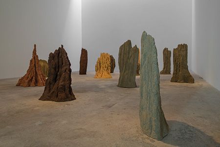 a group of rocks sitting on top of a cement floor next to each other in a room