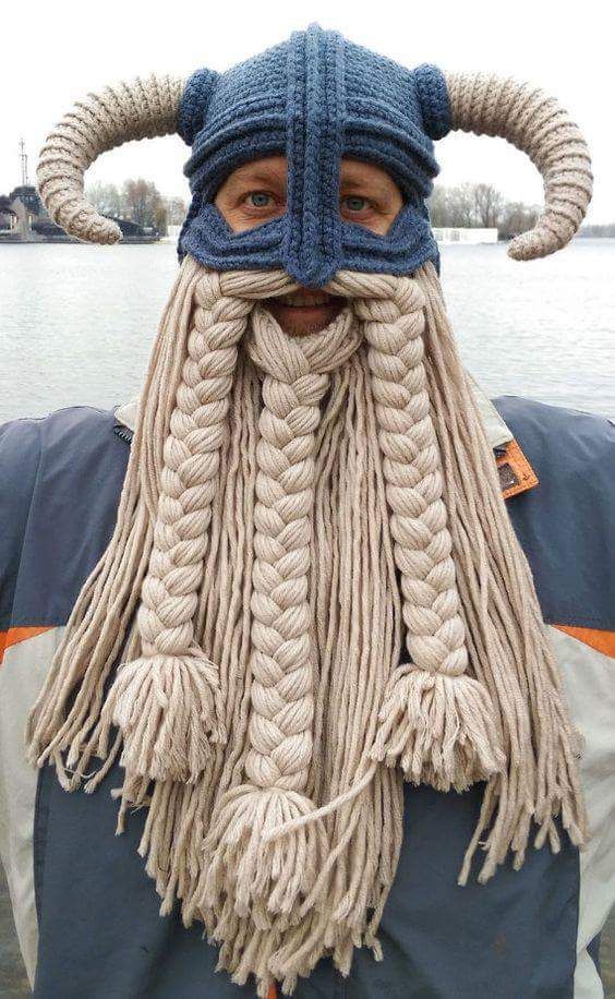 a man wearing a knit viking hat and braided beard