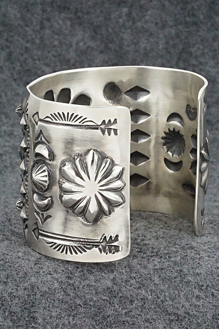 This stunning sterling silver bracelet was made by Navajo silversmith Elvira Bill. The inside is signed Elvira Bill and stamped sterling.Size: 5 7/8" (will fit up to a 7 1/4" wrist)Gap: 1 3/8"Width: 2"Free shipping on all orders! We ship with USPS and always include tracking. All orders ship within a day of payment.Returns are accepted up to 30 days after you receive your order. Just send us a message. Our shop offers cash back or store credit. The item must be returned in new condition. Artisan Sterling Silver Concho Cuff Bracelet, Artisan Silver Concho Cuff Bracelet, Southwestern Silver Bangle Jewelry, Southwestern Silver Bracelets With Concho, Southwestern Silver Bracelet Jewelry, Southwestern Style Silver Bracelet Jewelry, Southwestern Style Silver Bracelet, Southwestern Silver Bracelet, Sterling Silver Bracelet