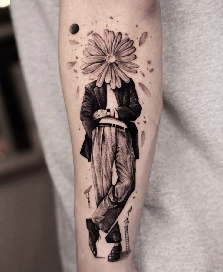 a man's arm with a flower and a clown tattoo on the left forearm