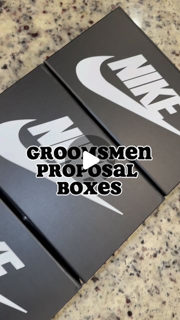 two black boxes sitting on top of a counter with the words groo's men proposal boxes