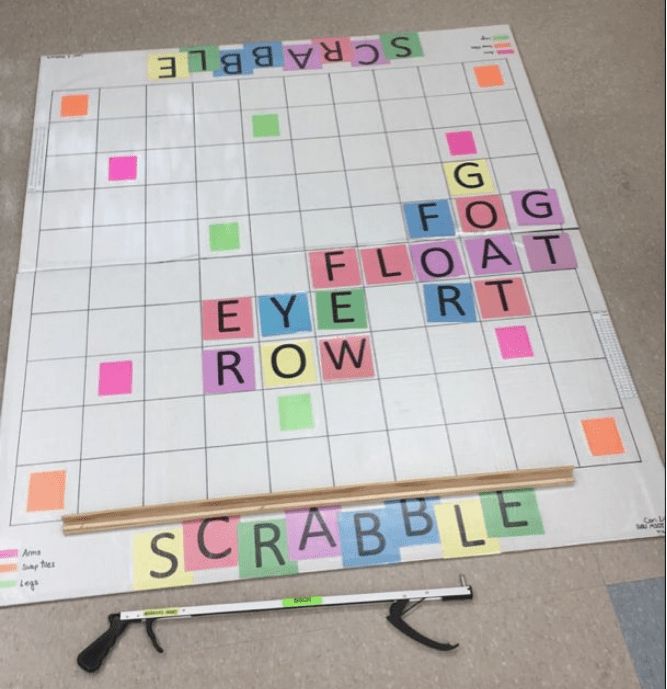 the scrabble game is laid out on the floor