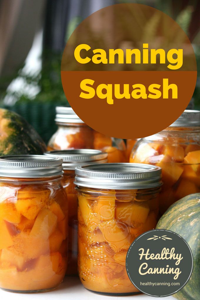 jars filled with canned squash sitting on top of a table