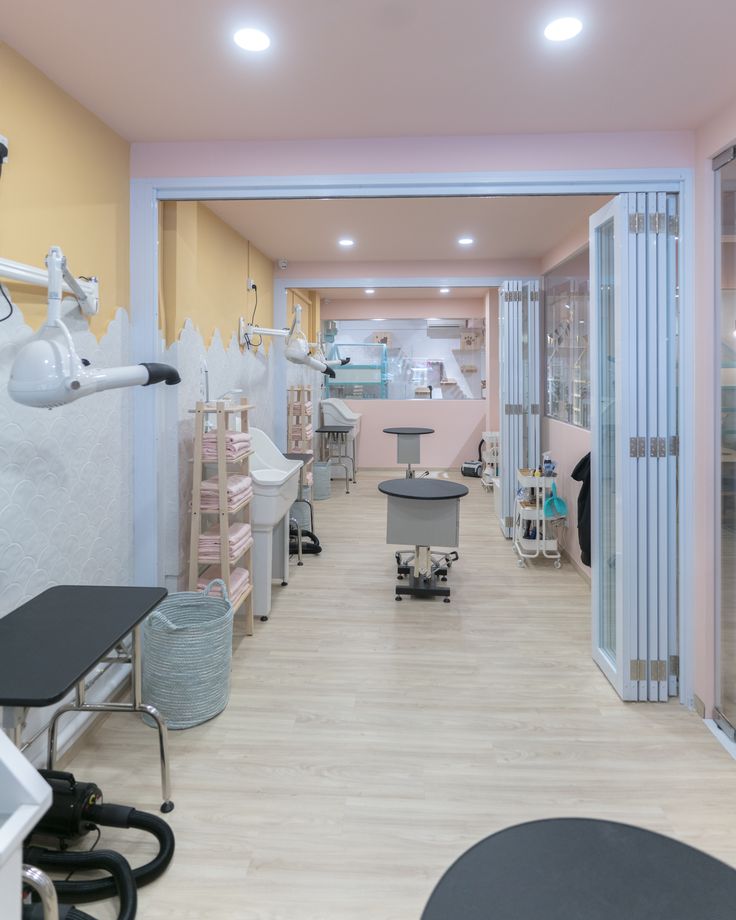 the interior of a dental office with chairs and equipment in it's center aisle