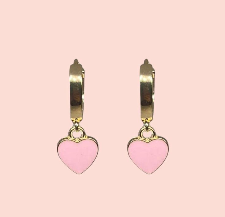 Gorgeous 18K Gold Plated Heart Huggies earrings with a baby pink enamel heart charm! Nickel free Apx hoop dimension (18K gold plated) - 16.5 x 14.5 x 13.5mm. Heart charm (enamel & alloy) - 12mm The perfect compliment to any outfit - treat yourself or a loved one to these special earrings. This item comes complete with a lovely pillow gift box Available in other colours from our Etsy store As with all jewellery, to keep in optimum condition, avoid showering in them and avoid any perfume contact. Pink Hoop Earrings For Valentine's Day, Cute Pink Hoop Earrings For Valentine's Day, Pink Enamel Hoop Earrings, Pink Heart Huggie Earrings For Valentine's Day, Pink Huggie Heart Earrings For Valentine's Day, Pink Heart Huggie Earrings For Pierced Ears, Pink Huggie Heart Earrings For Pierced Ears, Cute Pink Huggie Jewelry, Pink Heart Charm Huggie Jewelry