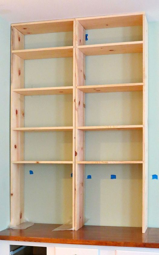 an empty bookcase with no shelves in the middle and blue paint on the walls