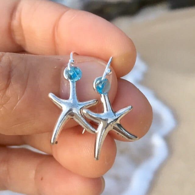 antique silver starfish on  elegant hypoallergenic stainless steel french hook ear wires choose from the following glass accent bead colors: * transparent aqua blue * transparent deep ocean blue  * get a great deal on both! * for a limited time get a free starfish wish bracelet! Handmade by me with Aloha in Hawaii PLEASE MESSAGE ME FOR LARGER QUANTITY OR DIFFERENT COLOR ACCENT BEADS they arrive ready for gifting inside a delicate deep ocean blue organza bag.  *to ensure safety in transit, earrings are now shipped inside a cute, reusable acrylic jar along with my Live Aloha card and organza bag* SEE ALL MY EARRINGS HERE: https://www.etsy.com/shop/LOphoto808?ref=br_feed_17&br_feed_tlp=art§ion_id=17783609 shipping additional items is FREE!! please contact me here: https://www.etsy.com/convers Starfish-shaped Earrings With Star Charm For Gift, Starfish Earrings With Star Charm As Gift, Nickel-free Ocean-inspired Earrings For Gift, Ocean-inspired Silver Jewelry For Beach Season, Silver Earrings With Starfish Charm As Gift, Ocean-inspired Hypoallergenic Jewelry As A Gift, Ocean-inspired Hypoallergenic Jewelry Gift, Starfish Nickel-free Earrings For Gift, Starfish-shaped Nickel-free Earrings For Gifts