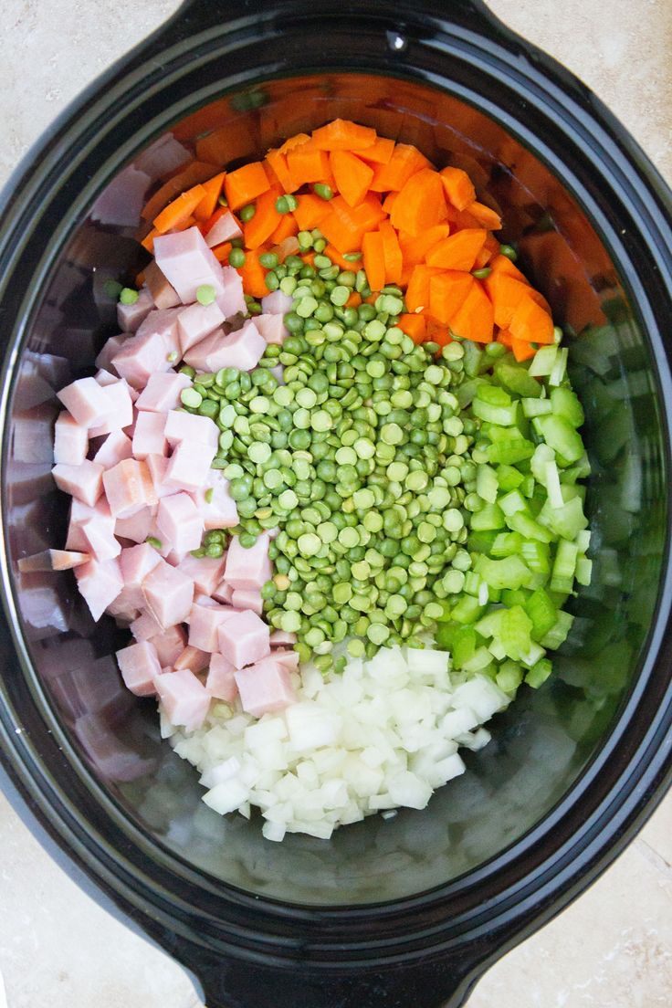 chopped vegetables and diced meat in a slow cooker