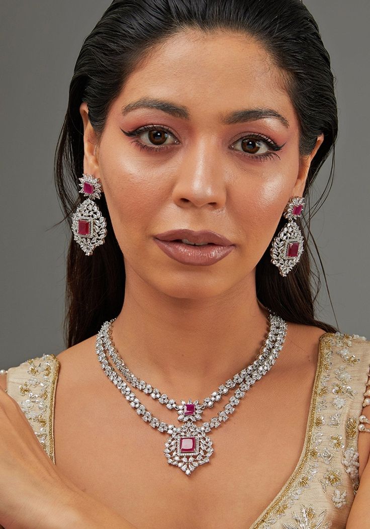 Double Layered Red Stone Faux Diamond Necklace Set Zevar by Geeta - Fabilicious Fashion Hand Set Ruby Bridal Necklace For Party, 3 Layer Diamond Necklace Indian, Dazzling Ruby Bridal Necklace For Parties, Festive Silver Necklaces With Diamond Accents, Dazzling Ruby Necklace For Party, Crystal Bridal Necklace With Jewels For Celebration, Hand Set Ruby Necklace For Party, Hand Set White Bridal Necklace For Party, Ruby Necklaces With Sparkling Stones For Party