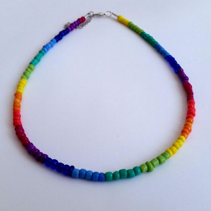 Colorful Rainbow Seed Beads Necklace This is a dainty beaded necklace, made with 9 different colors of pretty glass seed beads. It is on a beading wire and it has and extender for additional length. Let me know if you have any questions :) Happy shopping!! Rainbow Heishi Bead Necklaces With Letter Beads, Adjustable Rainbow Beaded Necklace, Rainbow Heishi Beads Necklace With Colorful Beads, Rainbow Necklaces With Tiny Round Beads, Rainbow Necklace With Tiny Round Beads, Colorful Czech Glass Beaded Necklace, Bohemian Rainbow Heart Beads, Rainbow Heishi Beads Necklace With Spacer Beads, Bohemian Rainbow Beaded Necklaces With Heart Beads