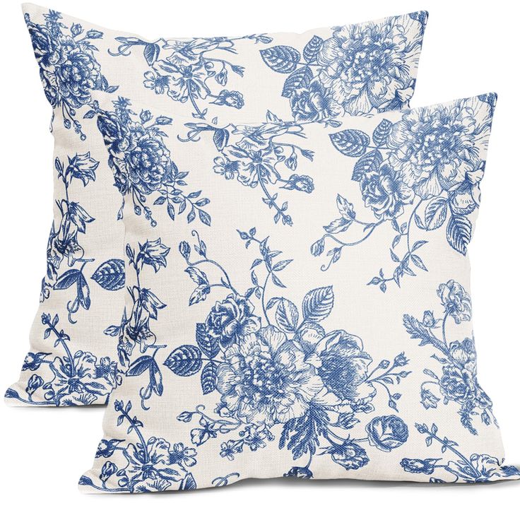 two blue and white pillows with flowers on them