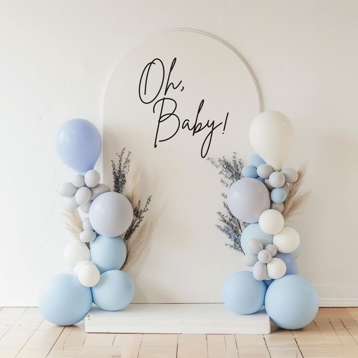 some balloons are hanging on the wall and there is a sign that says oh baby