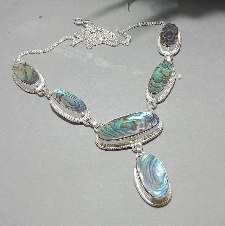 Amazing !! Natural Mother of pearl gemstone neckless / handmade gemstone neckless / princes neckless / silver plated neckless. Please, visit my shop to view more items https://artijewellerydesigns.etsy.com Handmade item Dispatches from a small business in India Read the full list of materials Materials: brass, silver, stone Stone Name : Mother of pearl Stone Shape : oval Neckless length: 21 inches  Description: We have Great Collection of Silver plated neckless  jewelry, which is absolutely unique and precious. princess neckless . it's a very beautiful and fancy design.    Our jewelry is always with  silver plated base material. The important thing is that when our precious gemstone confluences with these silver, it definitely becomes a precious jewelry . Read all measurements and descript Silver Gemstone Long Necklace, Long Mother Of Pearl Necklaces As Gifts, Mother Of Pearl Long Necklace For Gifts, Sterling Silver Necklaces With Jewels For Gifts, Silver Gemstone Pendant Custom Necklace, Bohemian Silver Pendant Pearl Necklace, Unique Gemstone Necklace With Mother Of Pearl, Bohemian Silver Pearl Pendant Necklace, Silver Shell Necklace With Pearl Pendant As Gift