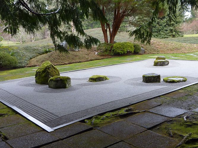 a japanese garden with moss growing on the ground and stepping stones in the middle, surrounded by trees