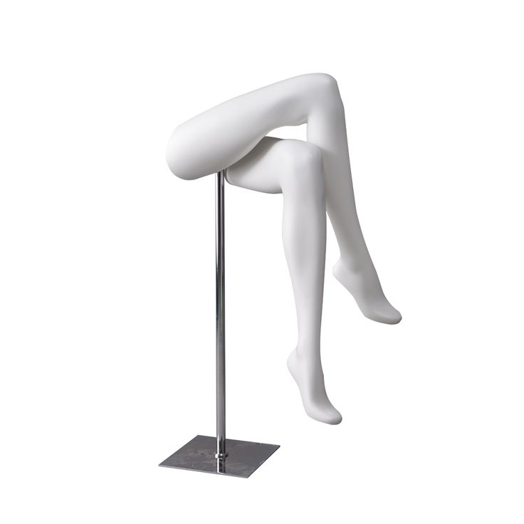 a white mannequin sitting on top of a pole with its legs spread out