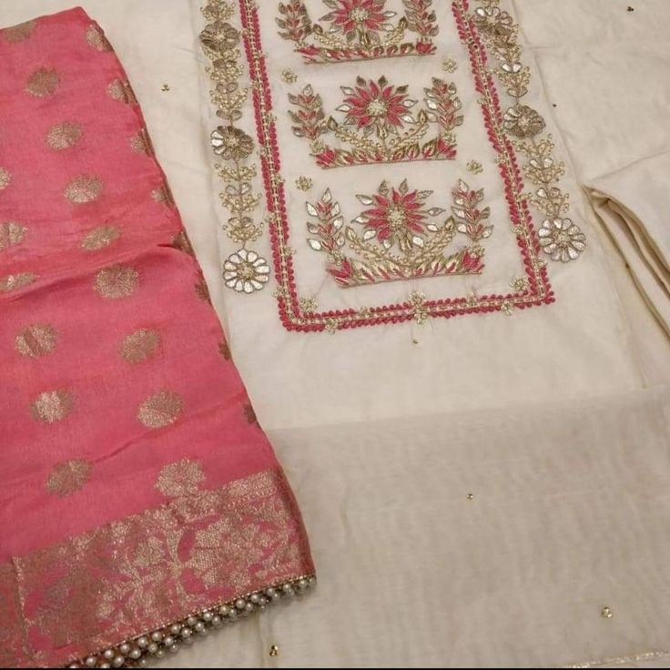 Item Overview Atharva Salwar Kameez w/Beautiful Embroidered Neck in Beige Chanderi/Banarsi Silk Dupatta/Wedding Dress/Customized Stitching Dno. CH1286C Fabric: * Shirt Chanderi Silk- 2.5 Mts, Beige * Dupatta: Banarsi Silk 2.5 Mts. Red (Motifs May Wary) * Bottom Santoon Silk 2.5 Mts. Excusive Hand Embroidered Party Wear Punjabi Suit. Customization: * Fabrics: Designs Can be made in different Fabrics. * Stitching Available Care: * Dry Clean/ Avoid direct Ironing on Embroidery Part. * You will need Wedding Unstitched Suit With Dabka Work In Traditional Drape, Eid Raw Silk Churidar With Intricate Embroidery, Eid Churidar With Intricate Embroidery In Raw Silk, Wedding Salwar Kameez With Intricate Embroidery In Jamawar, Eid Salwar Kameez With Resham Embroidery For Wedding, Wedding Kurta With Dabka Work On Jamawar, Bollywood Style Unstitched Suit With Dabka Work For Wedding, Bollywood Style Unstitched Suit For Wedding With Dabka Work, Bollywood Wedding Suit With Dabka Work