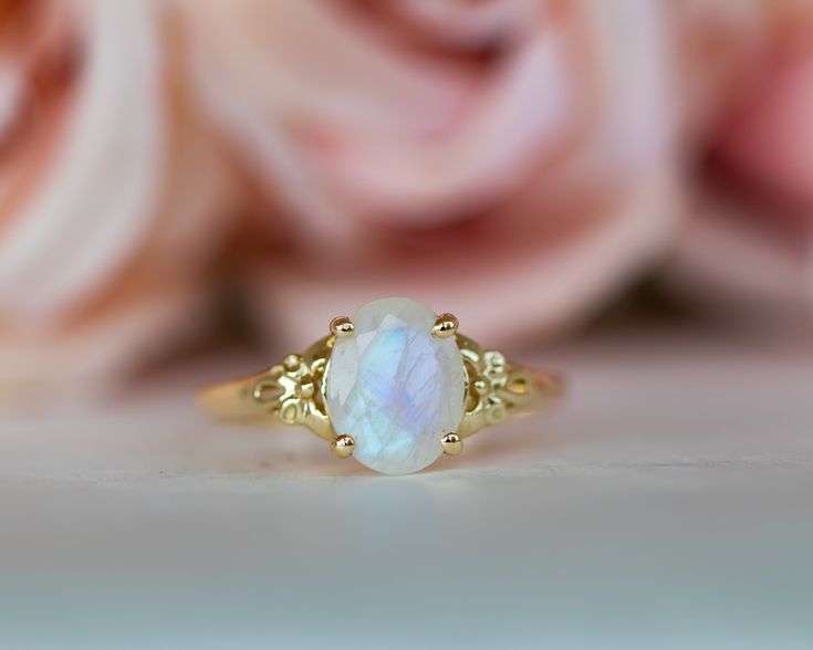 This is an oval moonstone ring, vintage style moonstone engagement ring, solitaire ring, moonstone engagement ring, gemstone ring, moonstone gold ring, oval engagement ring, a perfect moonstone engagement ring. This vintage style floral ring and has a dainty and feminine design, a solitaire vintage style with a natural oval rainbow moonstone, that symbolizes passion and endless love. This unique engagement ring is the best way to show your pure love for the one you love. ♥ Moonstone Gemstone mea Fine Jewelry Yellow Gold Oval Cabochon Moonstone Ring, Fine Jewelry Oval Moonstone Ring With Rose Cut Diamonds, Heirloom Yellow Gold Moonstone Ring, Oval Cabochon, Oval Cabochon Moonstone Ring In Yellow Gold, Oval Moonstone Gemstone Ring, Heirloom Yellow Gold Oval Cabochon Moonstone Ring, Heirloom Yellow Gold Moonstone Ring, Oval Cabochon Yellow Gold Moonstone Ring For Anniversary, Yellow Gold Oval Cabochon Moonstone Ring For Anniversary