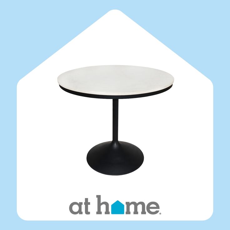 a white table with a black base and the words at home on it's side