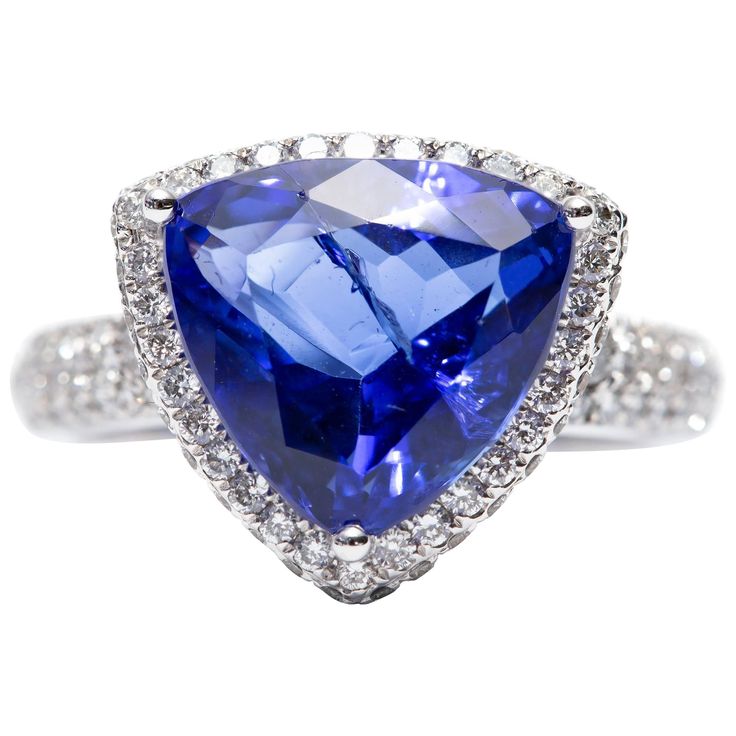 A beautiful 5.76 Carat modified triangle shaped Tanzanite engagement ring featuring 1.00 Carat of white color G clarity VS1 Round Brilliant Diamonds. Set in 18 Karat White Gold. UK size - N, USA size - 7 available in other carat sizes as well as ring sizes. British hallmarked by the London Assay Office. Carat Sizes, Of White Color, Tanzanite Engagement Ring, Ladies Diamond Rings, Triangle Shape, Ring Sizes, Brilliant Diamond, Jewelry Rings Engagement, The London