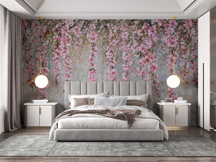 a large bed sitting in a bedroom next to a wall with pink flowers on it