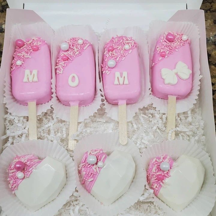 pink and white cake pops in a box