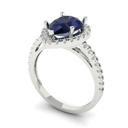 a white gold ring with a blue sapphire and diamonds