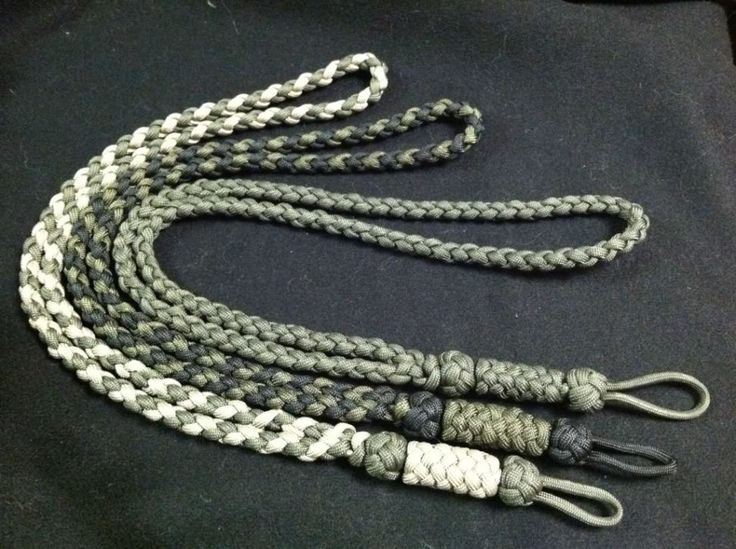 a gray and white rope with two ends on a black cloth covered seat belt,