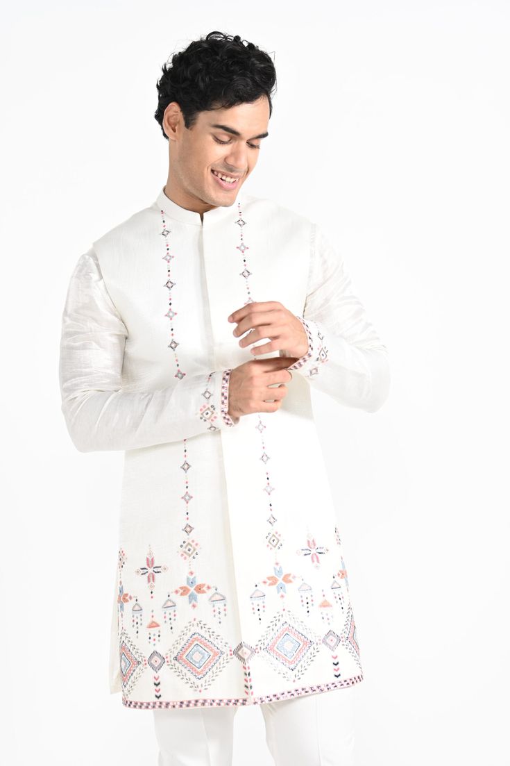 Ivory Phulkari inspired Nehru Jacket with pipe, cutdaana and thread work embroidery with same coloured kurta with embroidery detail on the chest and sleeve. this set in made in linen Satin, Paired with Ivory slim fit Pant Pajama. Color of
the actual garment may vary due to lighting conditions during the shoot.

Size Chart For Men





	
	
					Men's Size Chart
		

		
		
						
				Size Chart For Men
				Custom Size Measurement Guide
			
			
				
				
				Custom Size Measurement Guide
1. Take you White Semi-stitched Nehru Jacket For Festivals, White Semi-stitched Bandhgala With Zari Work, White Semi-stitched Bandhgala For Eid, Designer Anarkali Style White Sherwani, Designer Anarkali White Sherwani, Anarkali Style White Sherwani, Festive White Semi-stitched Nehru Jacket, Festive Bandhgala With Multicolor Intricate Embroidery, Festive White Semi-stitched Bandhgala