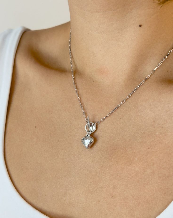 Edgy Aesthetic x Romantic Vibe = This 3D chrome heart necklace. Wear alone or stack it up for an even more unique look. Pair it with the matching bracelet for the perfect set. Details: Metal: Sterling Silver with Rhodium Plating & Anti-Tarnish Coating Pendant: 10.79 x 11.60mm Length: 17" Chain Toggle Clasp Sterling Silver Heart Pendant Charm Necklace, Tarnish Resistant, Sterling Silver Tarnish Resistant Heart Pendant Charm Necklace, Sterling Silver Tarnish Resistant Heart Pendant Necklace, Silver Double Heart Jewelry With Chain, Silver Double Heart Necklace Tarnish Resistant, Silver Double Heart Tarnish Resistant Jewelry, Silver Heart Necklace Tarnish Resistant, Silver Tarnish Resistant Double Heart Jewelry, Sterling Silver Open Heart Necklace, Tarnish Resistant