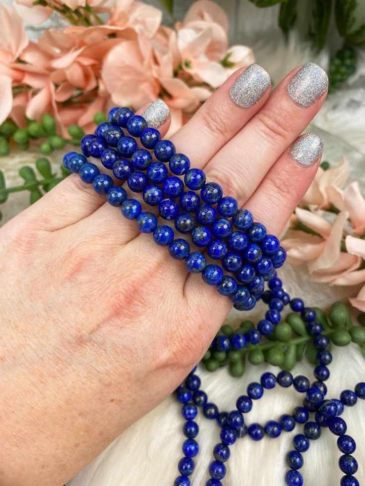 Wearing a Blue Lapis Lazuli bracelet not only makes a stylish accessory but also brings a wealth of symbolic meaning and metaphysical properties into your daily life. You will receive ONE Lapis Lazuli bracelet that is intuitively chosen for you.Approx Bead Size: 6-7mmApprox Size: 5.75" - 6.5" around. Colors and bead size may vary. Lapis Lazuli Bracelet Benefits Lapis Lazuli is renowned for its deep blue hue and has long been associated with enhancing communication, making it particularly benefic Blue Beaded Bracelets For Meditation, Holistic Blue Beaded Bracelets For Healing, Blue Hypoallergenic Spiritual Bracelets, Lapis Lazuli Round Beads Jewelry For Healing, Hand-strung Lapis Lazuli Bracelets For Meditation, Spiritual Blue Beaded Bracelets For Meditation, Hand-strung Lapis Lazuli Bracelet For Meditation, Blue Spiritual Stretch Bracelet For Meditation, Spiritual Hypoallergenic Blue Beaded Bracelets