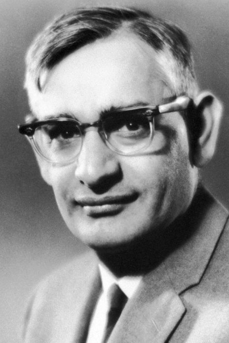 a black and white photo of a man wearing glasses