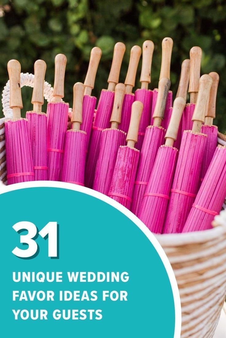 pink umbrellas in a basket with the words 31 unique wedding favors for your guests