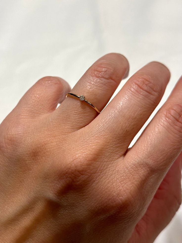 Details: Gemstone: Natural Cubic Zirconia, Brilliant Cut, 2mm Band: 14k gold filled, 18 gauge wire (1.09mm thick) The Ring size is 5 (US). Only this size is available for now.   A perfect gift for someone special or yourself. This beautiful dainty ring is the perfect tiny gemstone stacker.  This listing is for ONE ring. Perfect ring for everyday wear.  Each piece is handcrafted and made-to-order, specifically for you. Although I do my best to get orders out as quickly as possible. Dainty Diamond Promise Ring With Birthstone, Minimalist Cubic Zirconia Birthstone Ring With Gemstone, Minimalist Cubic Zirconia Gemstone Rings, Minimalist Crystal Ring With Diamond Accents, Diamond Birthstone Crystal Ring As Gift, Minimalist Diamond Birthstone Ring As Gift, Minimalist Diamond Birthstone Promise Ring, Minimalist Birthstone Diamond Promise Ring, Dainty Gold Solitaire Crystal Ring