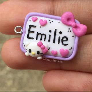 a hello kitty keychain with the name emlie on it's side