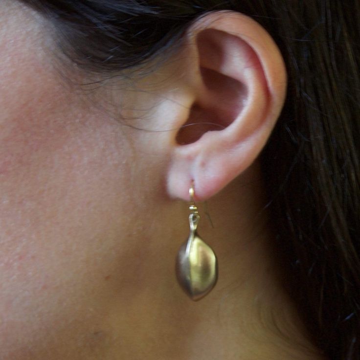 Bronze Amulet on gold-filled earwire; 1 inch. Early primitive crafting techniques have influenced the imperfect form and texture of this design. You may also like the Black Amulet Bronze Earring, the Tribal Hoop Bronze Earring and the Birdcage Bronze Earring. Limited edition. Handcrafted in the USA. Bronze Nickel-free Drop Earrings, Nickel-free Bronze Long Drop Jewelry, Nature-inspired Drop Earrings With Lever Back Ear Wires, Bronze Brass Long Drop Earrings, Handmade Bronze Long Drop Jewelry, Artisan Long Drop Gold Jewelry, Handmade Bronze Brass Teardrop Earrings, Nickel-free Bronze Teardrop Earrings, Artisan Teardrop Earrings With Lever Back Ear Wires