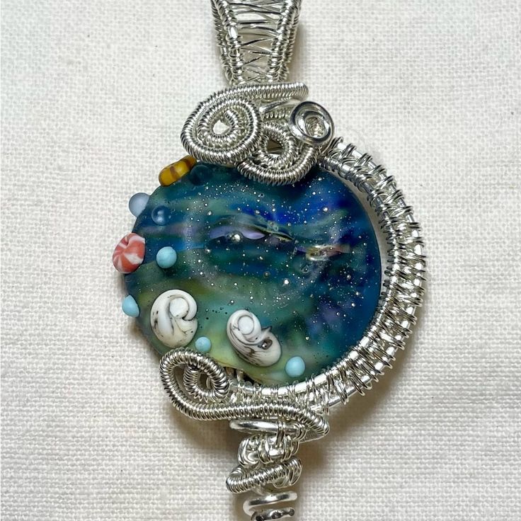 Stunning. Unique Wire Wrapped Ocean Design Pendant In Gorgeous Blue, Indigo, Green Hues. 2 Inches Tall By 1 Inch Wide. Sterling Silver And Resin. Wire Wrapped Jellyfish, Artistic Blue Beaded Necklace, Whimsical Round Blue Jewelry, Whimsical Blue Round Jewelry, Handmade Blue Glass Necklaces, Blue-green Round Beads Jewelry Gift, Blue-green Round Beads Jewelry For Gifts, Artistic Blue Jewelry With Large Pendant, Handmade Light Blue Glass Jewelry