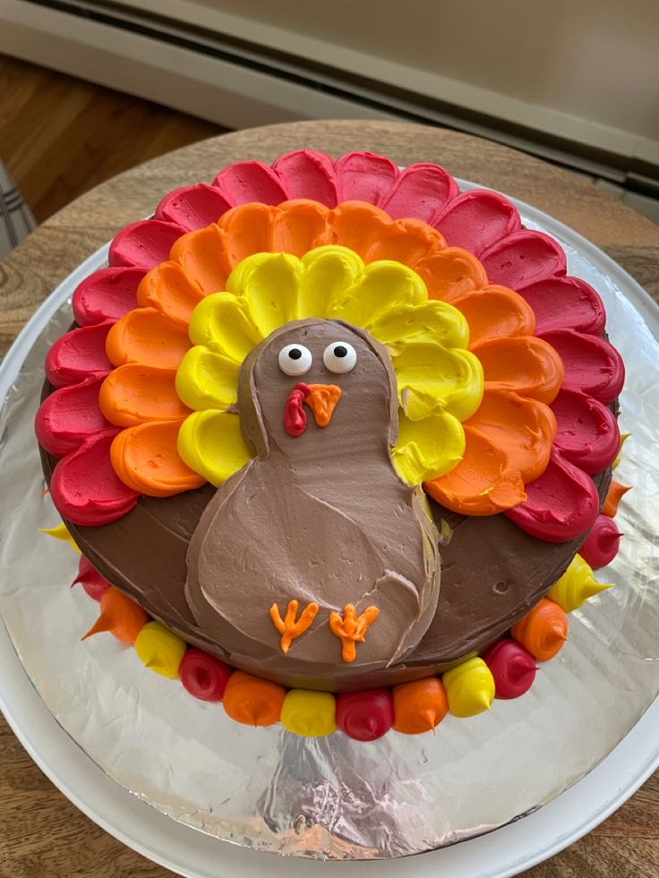 a cake decorated like a turkey sitting on top of a table