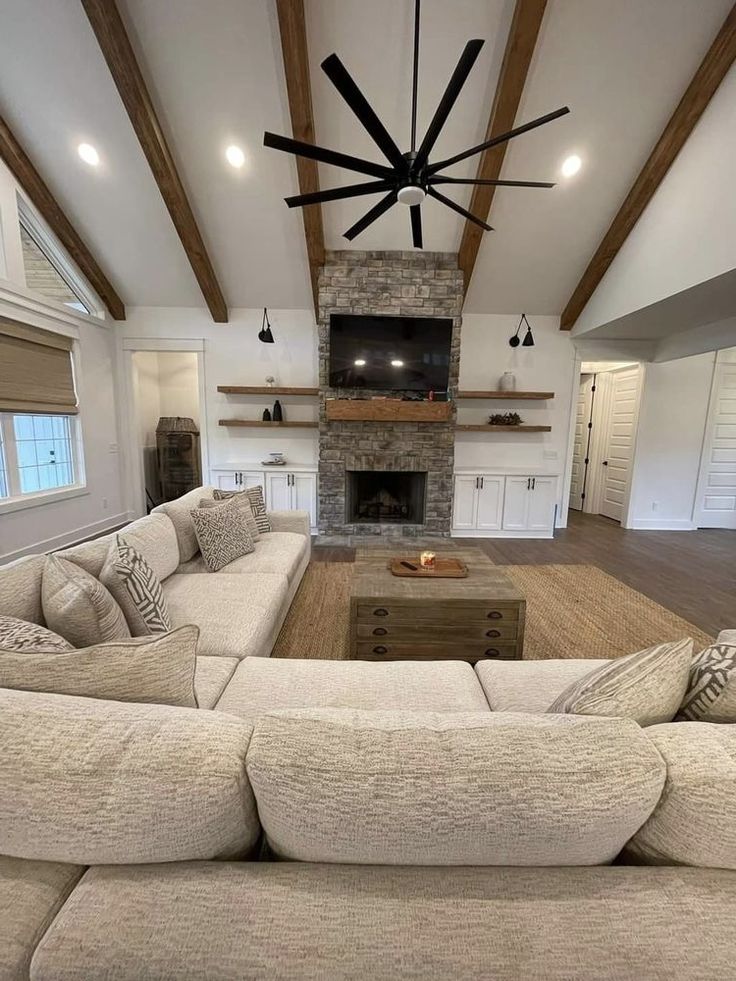 a large living room with couches and a fireplace