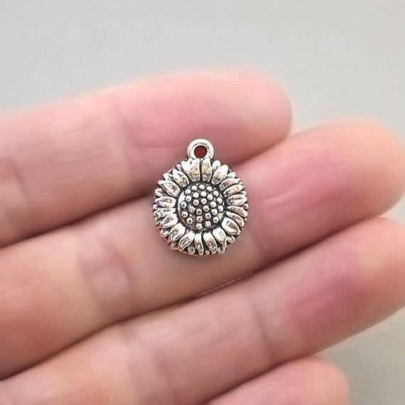 Sunflower charms, daisy flower pendant beads in antique silver finish.Shape: lovely solid sunflower or daisy disc (single sided)Quantity: 30pcs in one packageSize: approx. 15X18mm or 9/16"X11/16"Color: antique silverAntique bronze version: https://www.etsy.com/ca/shop/beadtoyou?search_query=CM1515BCheck out my other flower charms: https://www.etsy.com/ca/shop/beadtoyou?search_query=flowerAll my findings are lead free, nickle free/nickle safe. Nickel Free Adjustable Round Pendant Charms, Adjustable Nickel-free Round Pendant Charms, Adjustable Pendant Charms For Jewelry Making, Inspirational Nickel-free Silver Charm Necklaces, Nickel-free Silver Round Charm Necklaces, Inspirational Silver Nickel-free Charm Necklaces, Silver Charm Necklace With Round Pendant For Friendship, Inspirational Silver Charm Necklace With Round Pendant, Personalized Round Metal Charms