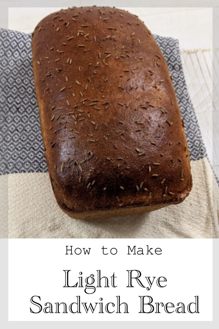 a loaf of light rye sandwich bread sitting on top of a towel