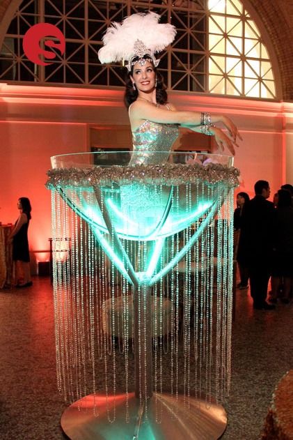 a woman standing on top of a table covered in lights