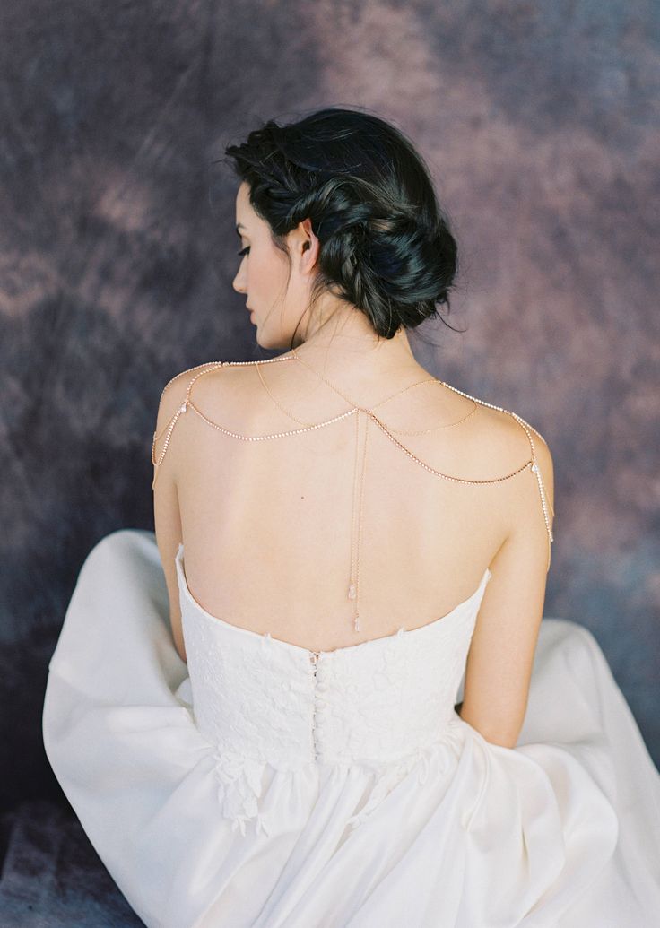 a woman in a white dress sitting down