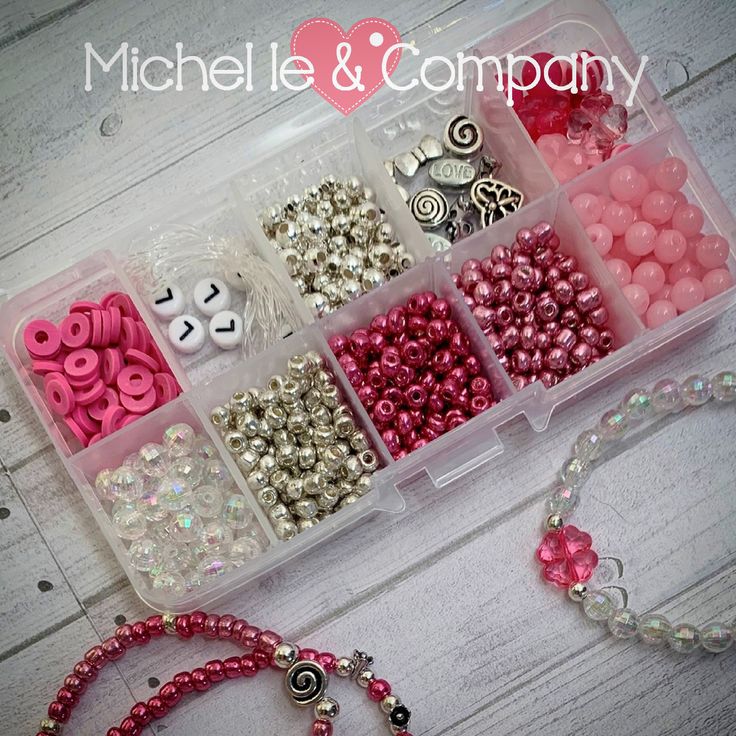 a box filled with lots of different types of beads and buttons next to a necklace