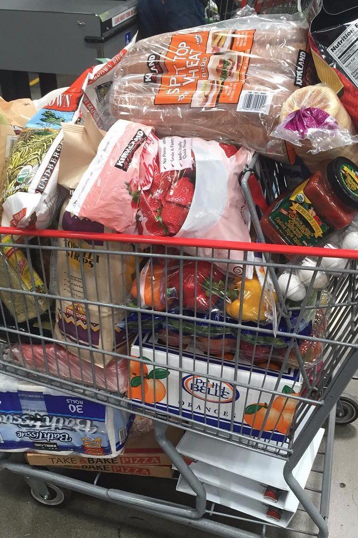 a shopping cart filled with groceries and food