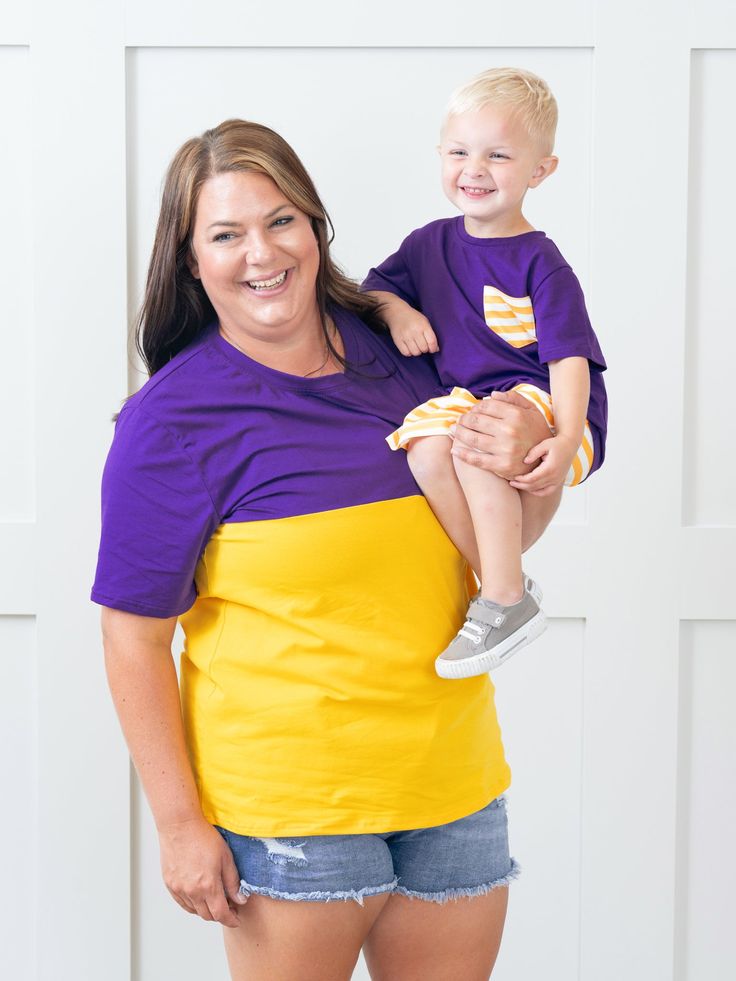 Unisex Purple & Gold Color Block Shirt Casual Purple Game Day Top, Casual Purple Tops For Game Day, Multicolor Cotton Tops With Team Name, Family Matching Game Day Tops With Short Sleeves, Family Matching Cotton T-shirts For Game Day, Collegiate Purple Cotton Tops, Purple Collegiate Cotton Tops, Purple Cotton Collegiate Tops, Collegiate Team-colored Tops With Contrast Stripes