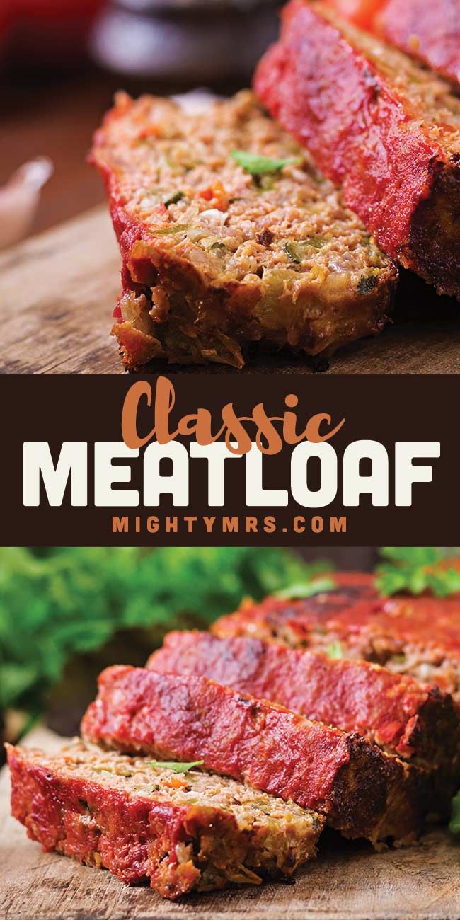 sliced meatloaf on a cutting board with lettuce and sauce in the background