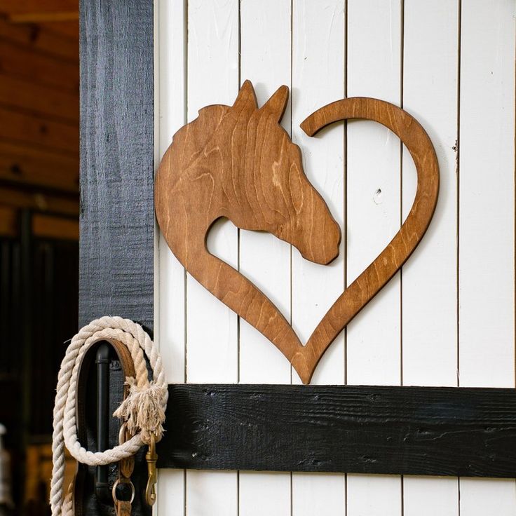 a horse's head carved into the side of a white wall with a rope