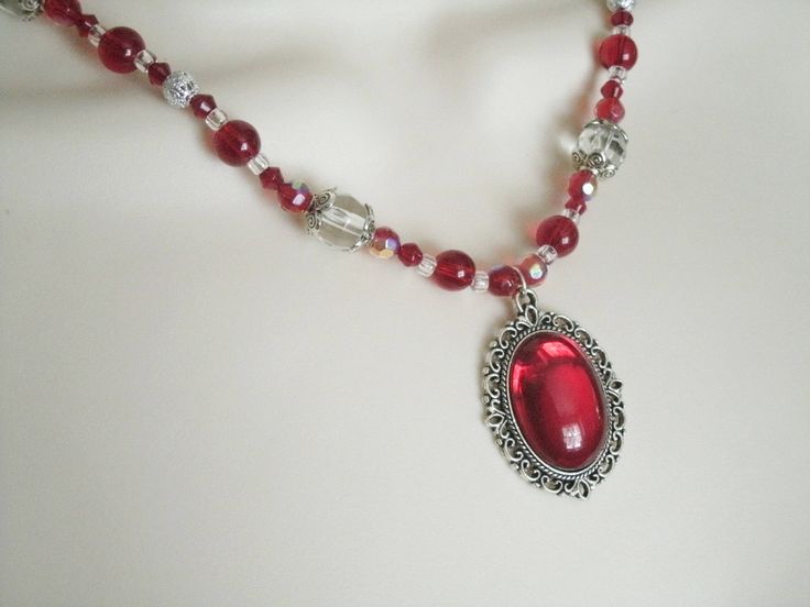 "Red Necklace This beautiful necklace has red glass beads, clear glass beads, seed beads, sterling silver plated filigree beads, sterling silver plated bead caps and a pewter silver pendant with red glass setting. 18\" long. Sterling silver plated toggle clasp." Antique Beaded Necklace With Faceted Beads For Gift, Antique Beaded Necklaces With Faceted Beads As Gift, Antique Beaded Necklace With Faceted Beads As Gift, Gothic Red Jewelry Gift, Red Gothic Jewelry Gift, Red Gothic Jewelry For Gift, Silver Beaded Necklaces For Valentine's Day, Antique Red Necklace For Wedding, Victorian Necklace For Formal Valentine's Events